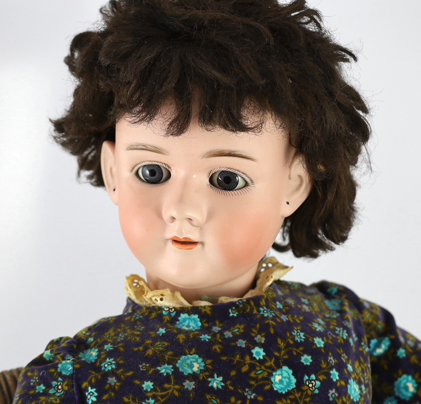 A Heinrich Handwerck bisque doll, German, circa 1900, 33in. Please note the chair is for display purposes only.